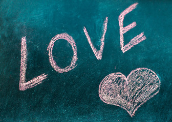 Word love is drawn in chalk. Valentine's Day