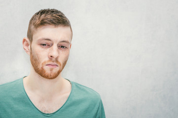 Portrait of a young guy with a sad look. Free space