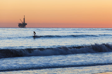 Fototapeta premium Surfer and Oil Rig