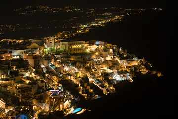 Fira town aerial view at night time, Santorini.