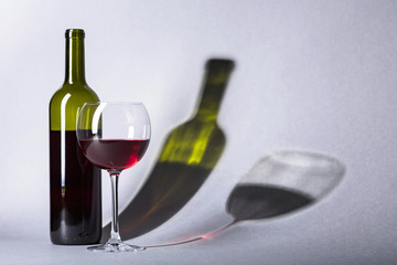 Glass and bottle of red wine.