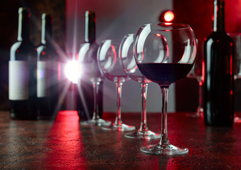 Glasses and bottles of red wine.