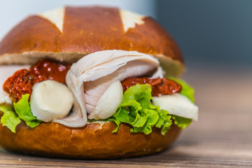 Fresh baguette sandwich on wooden background. Classic BLT sandwiches. Close up.
