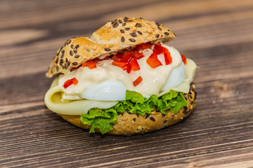 Fresh baguette sandwich on wooden background. Classic BLT sandwiches. Close up.