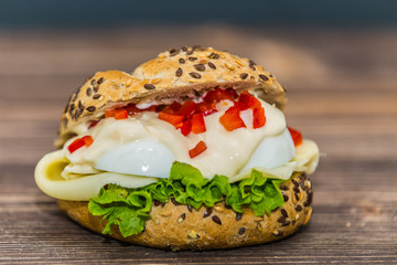 Fresh baguette sandwich on wooden background. Classic BLT sandwiches. Close up.