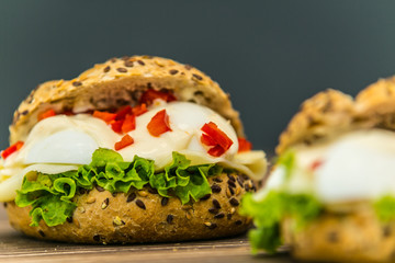 Fresh baguette sandwich on wooden background. Classic BLT sandwiches. Close up.