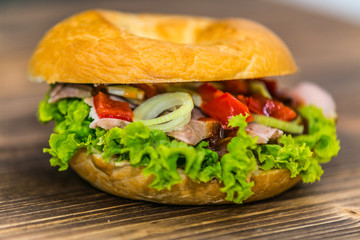 Fresh baguette sandwich on wooden background. Classic BLT sandwiches. Close up.
