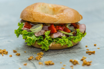 Fresh baguette sandwich on wooden background. Classic BLT sandwiches. Close up.