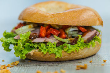 Fresh baguette sandwich on wooden background. Classic BLT sandwiches. Close up.