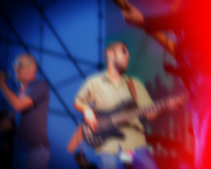 guitarist during a concert at night on a city street.