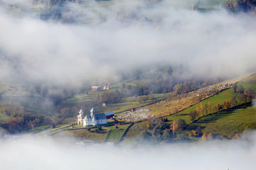 Foggy autumn morning above the traditional romanian cottages