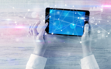 Hand using tablet with linking graphs charts  report and informational flow concept
