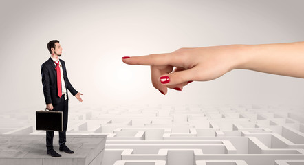 Young businessman blindly in love in the middle of an infinity maze concept
