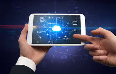 First person view of a hand using tablet with cloud office concept
