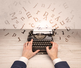 First person perspective elegant hand writing on typewriter with flying letters concept
