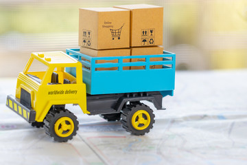Transport truck with cardboard box with symbols, shopping cart, up, recycle, fragile, keep dry, on street map. Logistics and transportation management ideas and Industry business commercial concept.