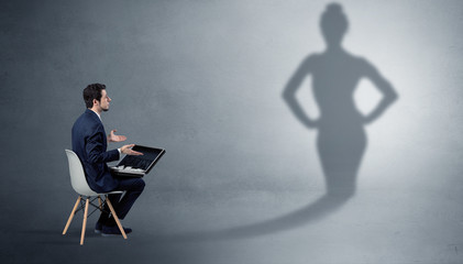 Rich businessman staying and offering stuffs to a pretty shadow woman
