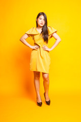 Beautiful young Asian woman in yellow dress