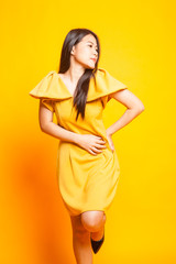 Beautiful young Asian woman in yellow dress