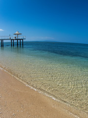 A Long Pier over a Tropical Blue Clear Sandy Beach with No Clouds on Clear Day in Ishigaki, Okinawa Japan