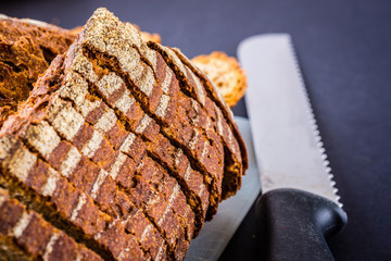 Sliced bread over a white surface and dark background.