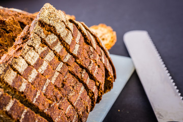 Sliced bread over a white surface and dark background.