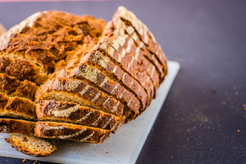 Sliced bread over a white surface and dark background.