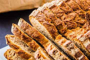 Sliced bread over a white surface and dark background.