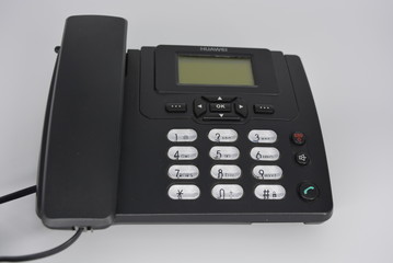 Black stationary home telephone with antenna, telephone base, plastic office telephone with a screen on a white background