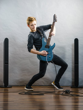 Young man playing electric guitar
