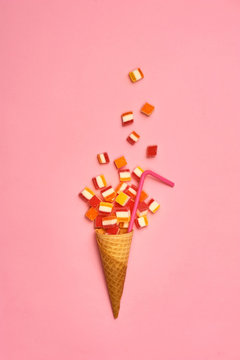 Flat lay : Ice cream cone with colorful party streamers on yellow background with copy space