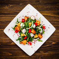 Caesar salad on wooden table
