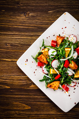 Caesar salad on wooden table