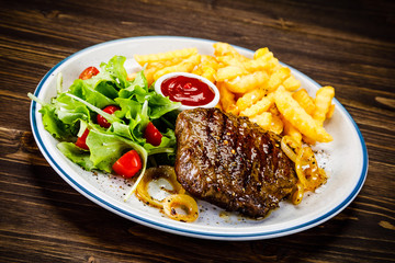 Grilled steak, French fries and vegetables