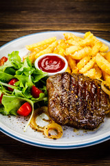 Grilled steak, French fries and vegetables