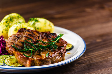Grilled steak with potatoes and vegetables