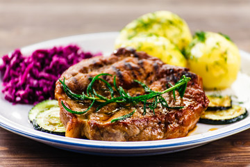 Grilled steak with potatoes and vegetables