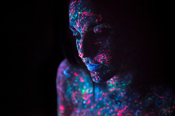 Girl painting with neon paints