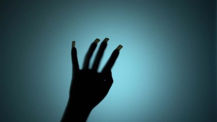 Creepy hand with long nails beating on glass, monster at the door, spooky scene. Blood-chilling horror thriller shot