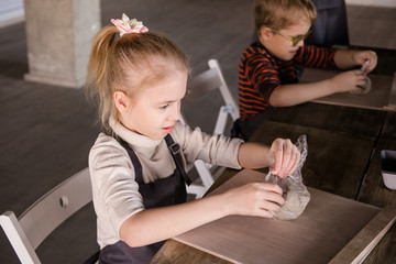 Blonde girl sculpts from clay