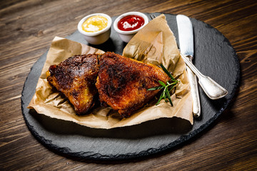 Grilled chicken legs with french fries and vegetables