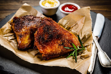 Grilled chicken legs with french fries and vegetables