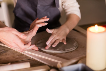 Little boy sculpts from clay with interest