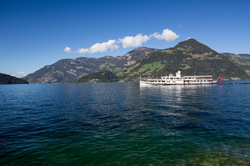 White boat with passengers on a lake in Switzerland