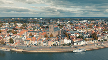 Fototapeta na wymiar Panoramic view of the Dutch medieval city of Deventer in The Netherlands seen from the other side of the river IJssel with central the principal church at the market square and wider landscape