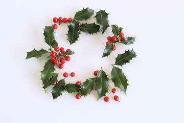 Christmas holly with red berries. Traditional festive decoration. Holly branch with red berries on...