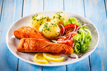 Grilled salmon with boiled potatoes, asparagus and vegetable salad