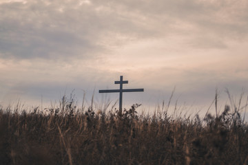 The cross seen from behind the grassy hill