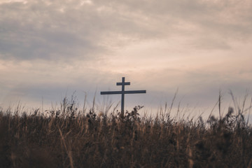 The cross seen from behind the grassy hill