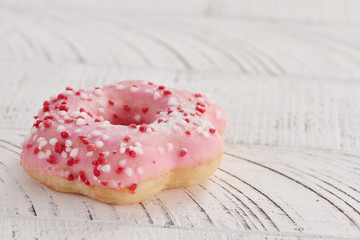 Tasty donuts on white wood background